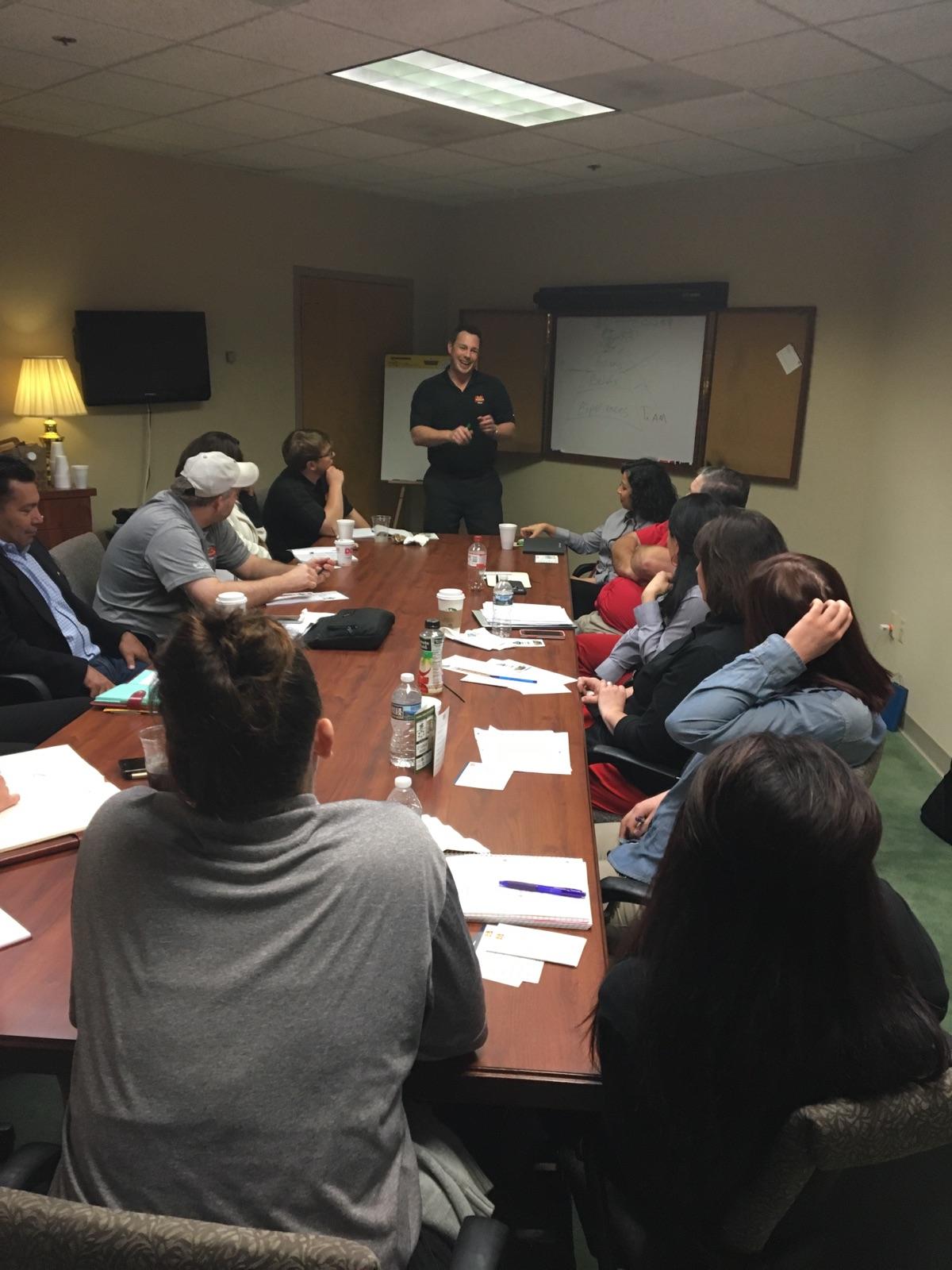 Jason Lowder leading a Local Store Marketing training around a boardroom table