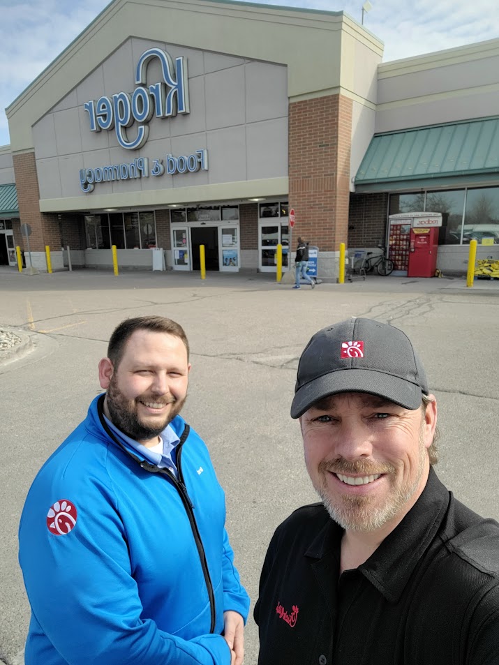 Jason Lowder and a Chick-fil-A operator on a route stop outside a neighboring grocery store
