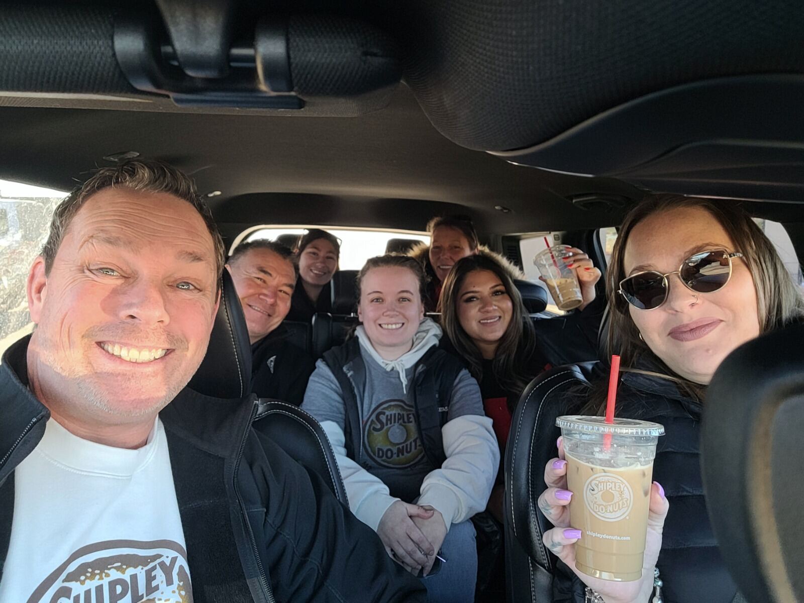Shipley Do-Nuts team mid-route handing out iced coffees