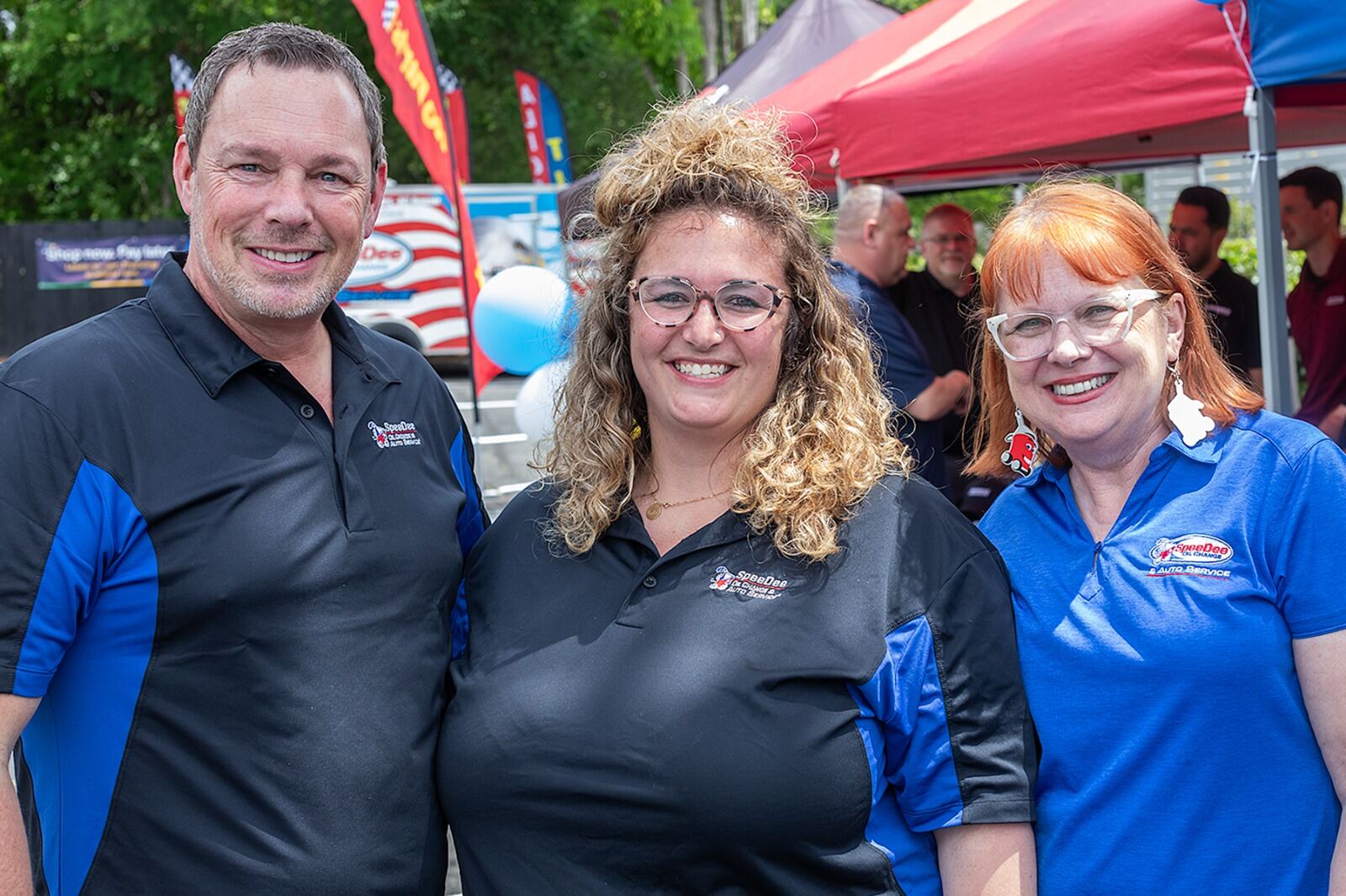 SpeeDee Oil Change team smiling at a local event