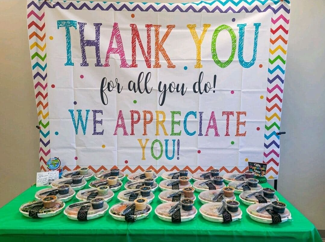 Thank-you banner over packaged meals delivered to a local office